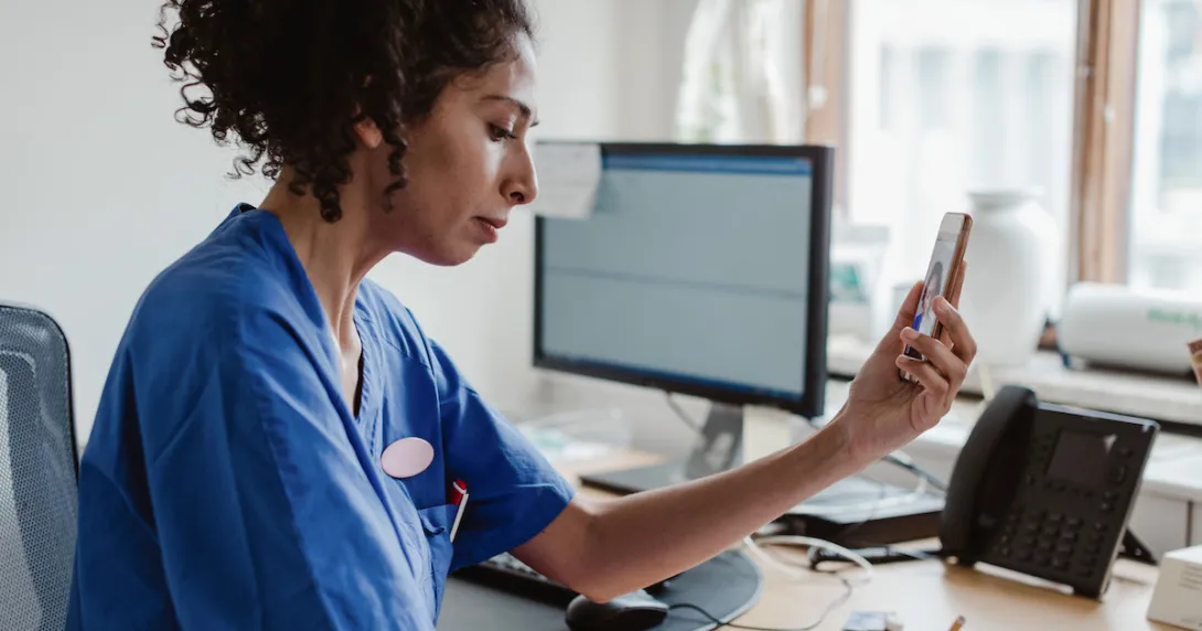 Clinician uses a mobile app for mental health support.