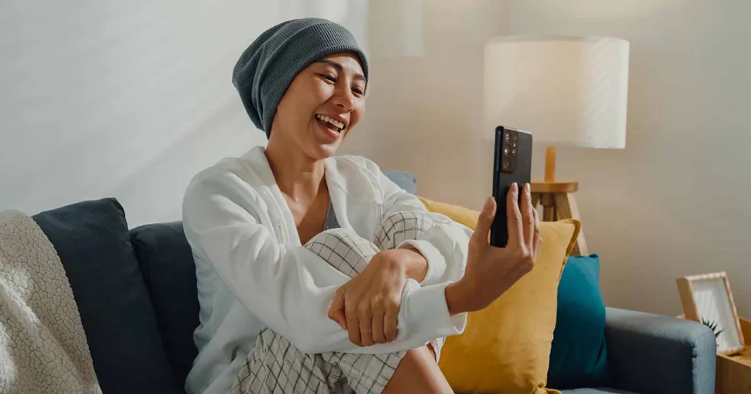 Smiling person looking at a smartphone