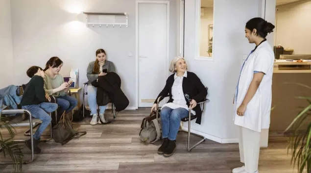 Nurse calls for a patient in a waiting room