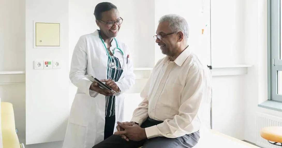 Doctor showing tablet to patient