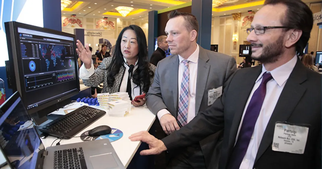 People in suits at a computer screen
