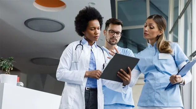 Healthcare workers looking at clipboard