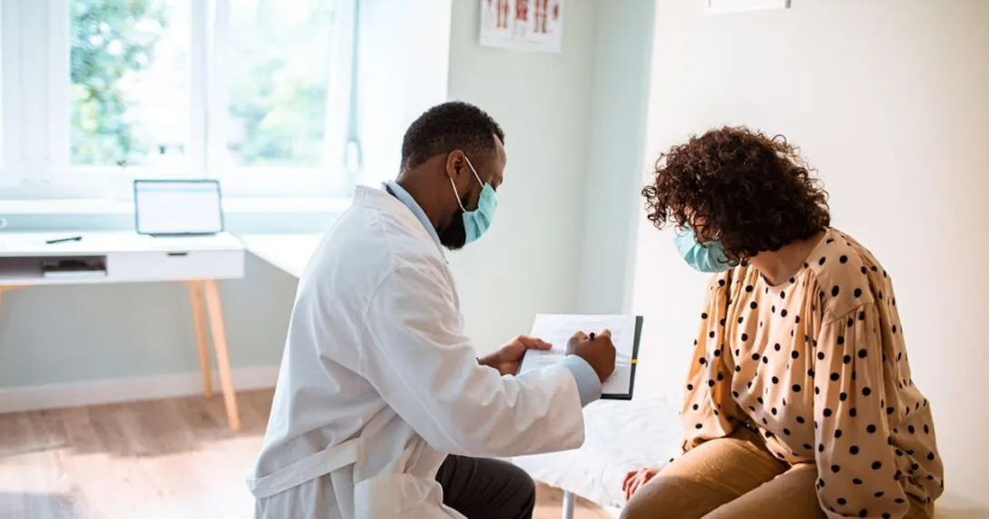 Doctor reviews treatment plan with patient in exam room