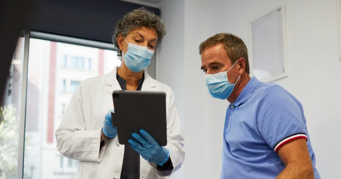 Doctor and patient look at information on a tablet