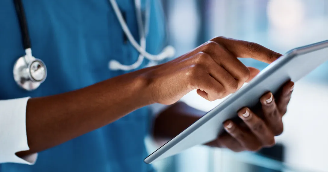 healthcare professional using a tablet