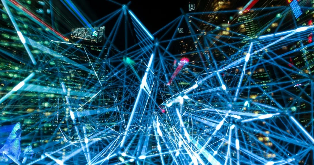 Data exchange represented by blue lights with a city in the background