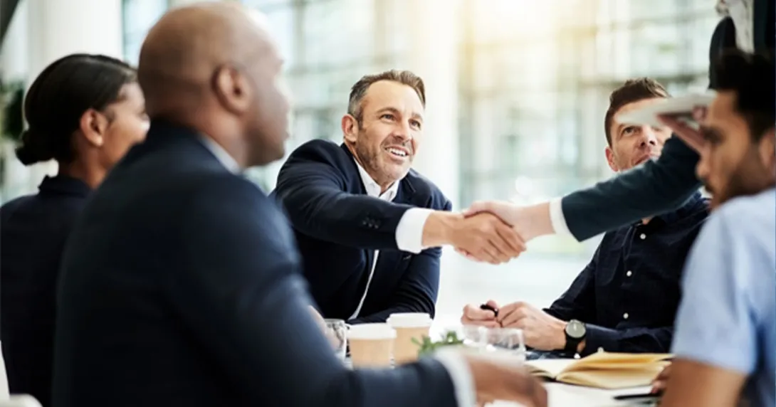 Handshake at a conference room table