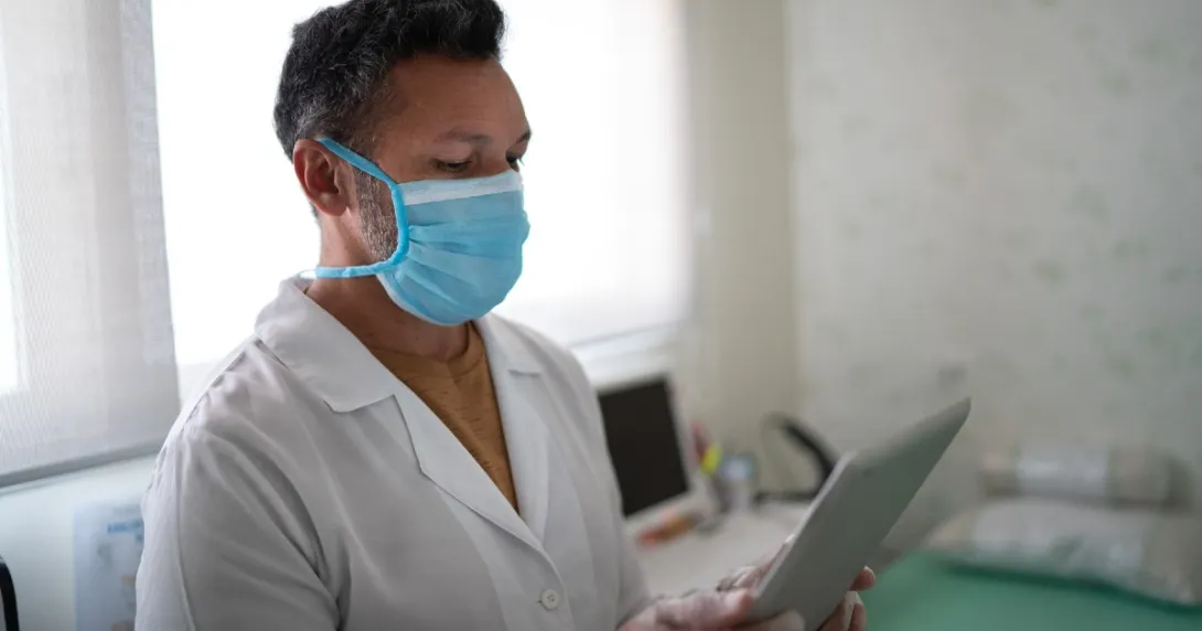 Nurse checks her tablet