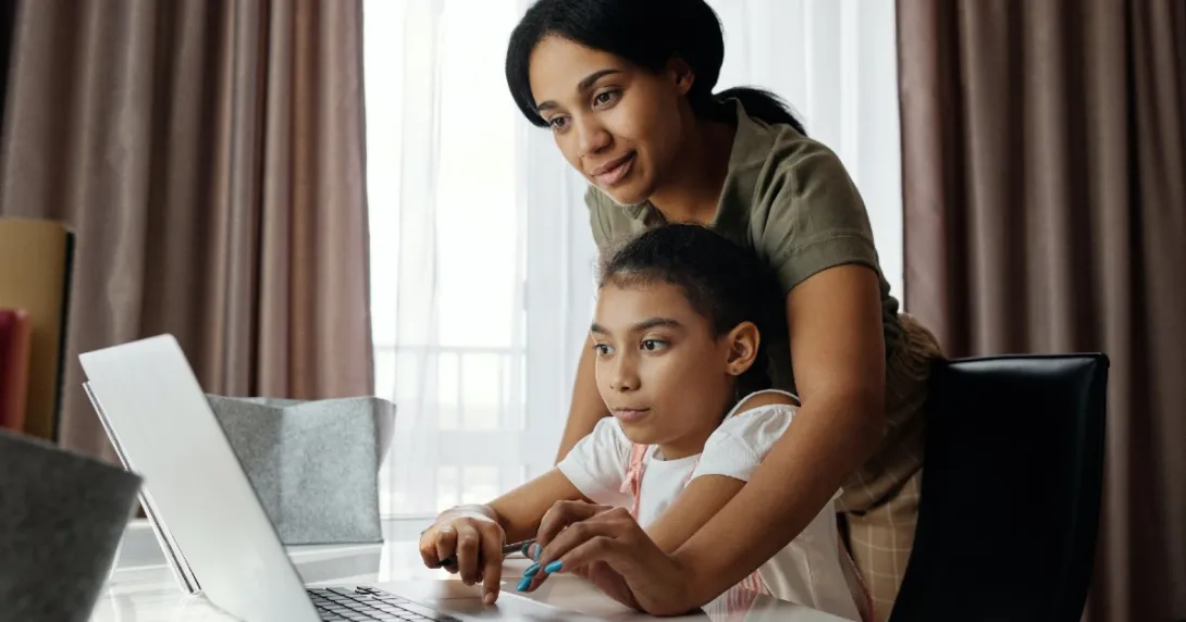 Adult and child at a laptop