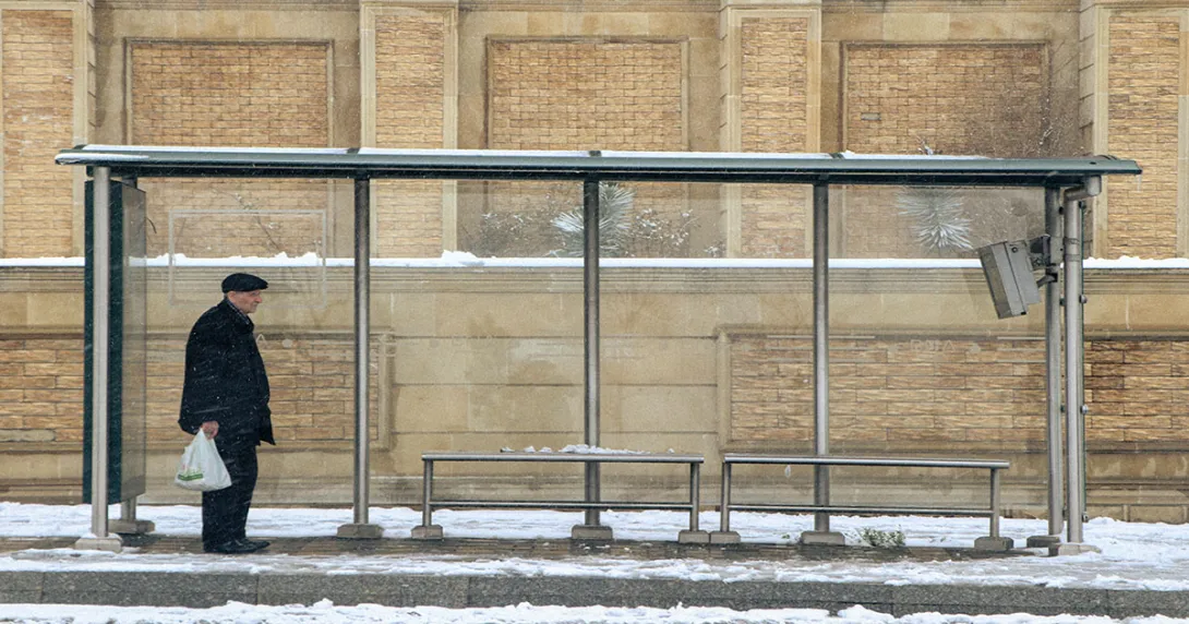 Person at bus shelter in winter