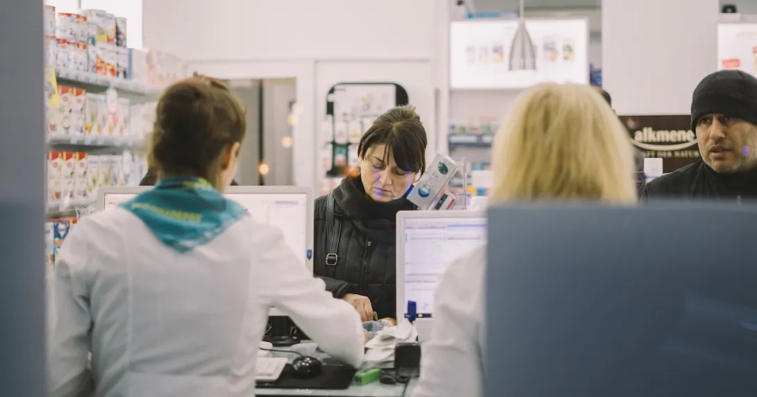 Customers transacting at a pharmacy counter