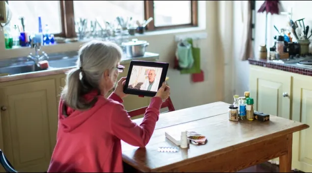 Person attending telehealth appointment on a tablet