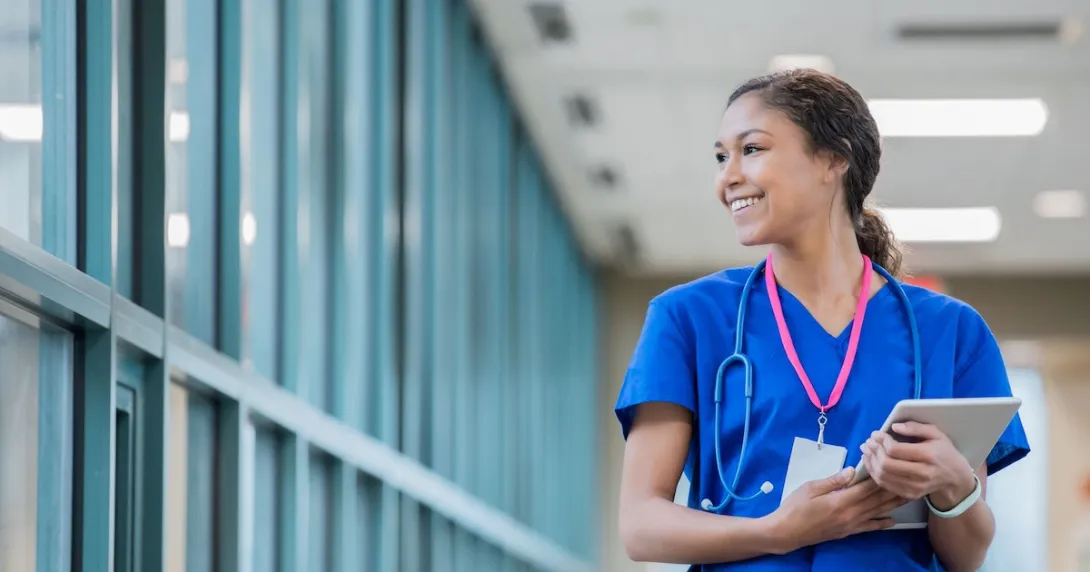 Smiling healthcare worker holding tablet