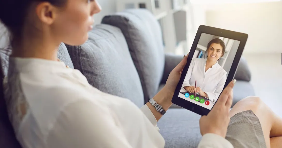 Person talking to healthcare provider on a tablet