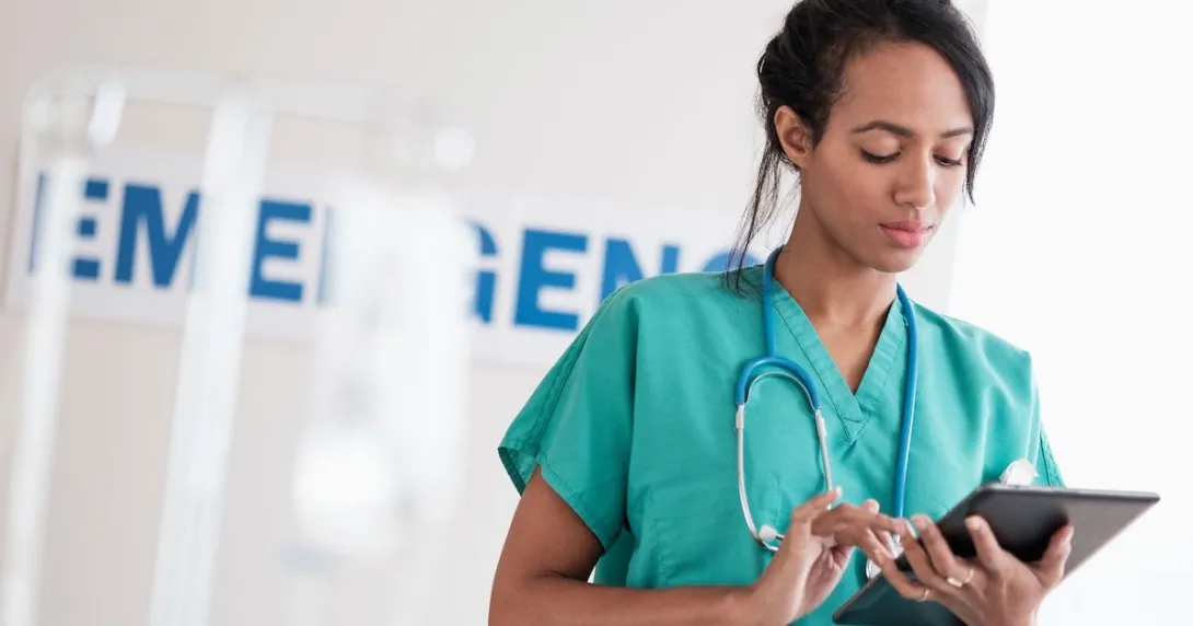 Healthcare worker using a tablet in a hospital
