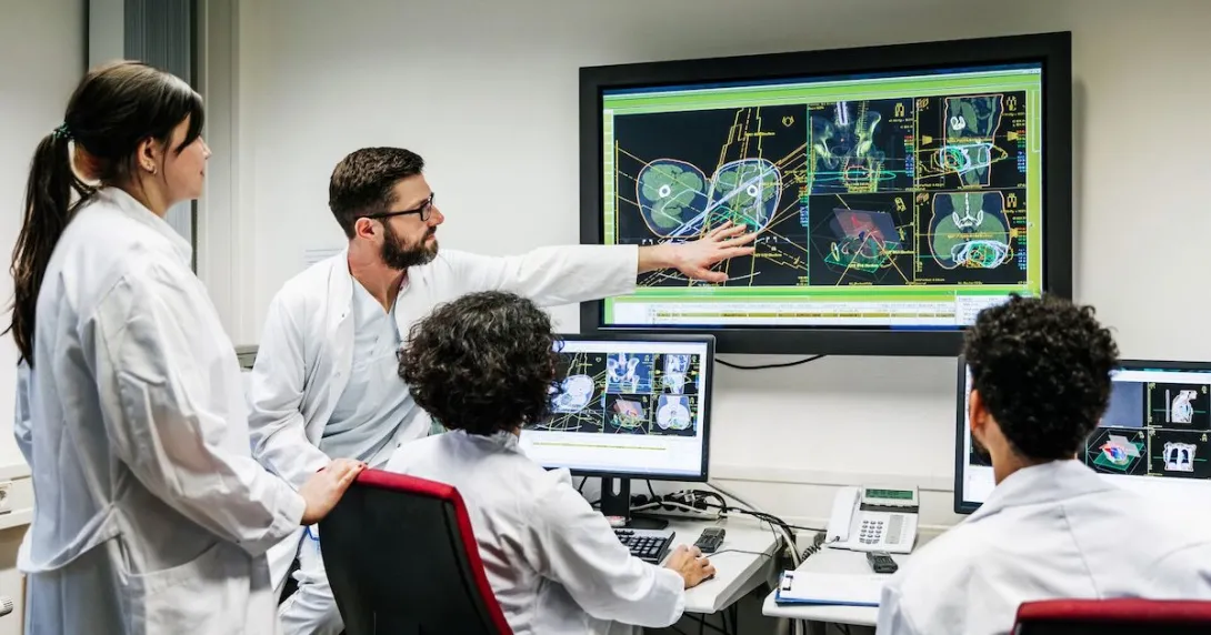 Healthcare professionals examine a screen image