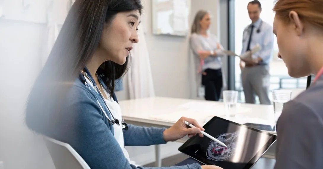 Doctors reviewing a patient's brain scan