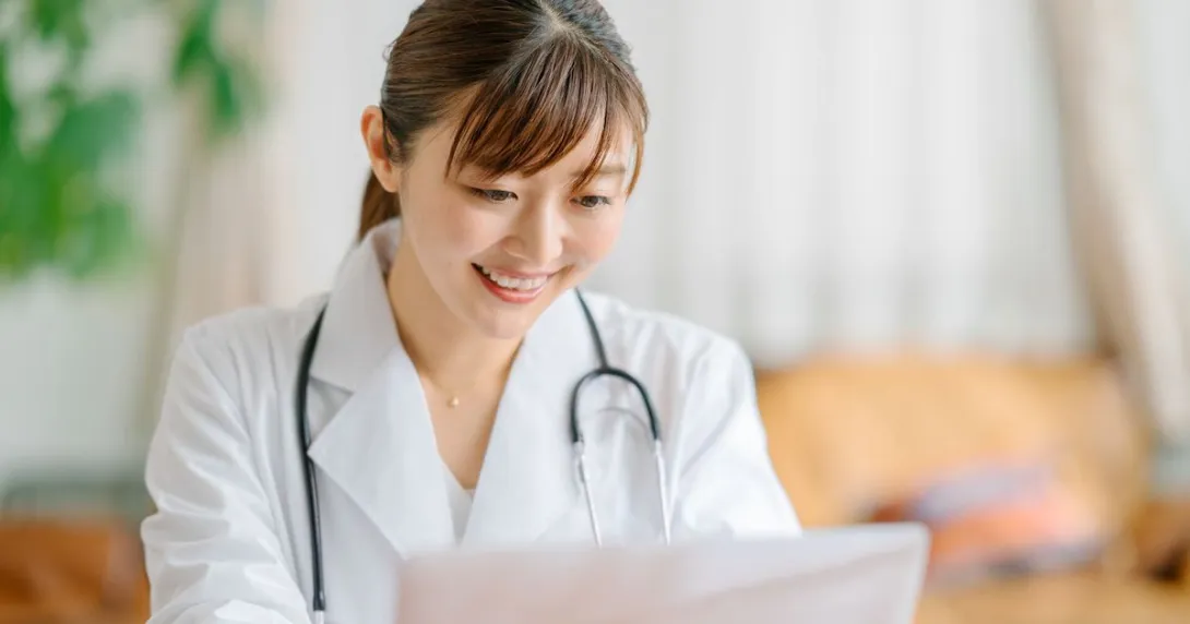 A smiling doctor studying a patient's brain images