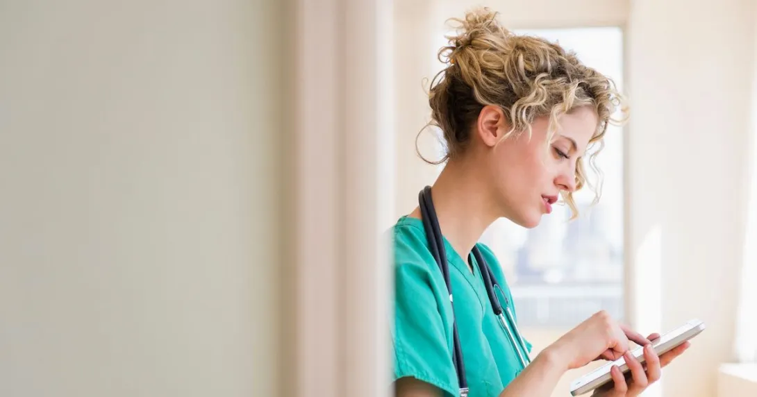 A nurse using a digital tablet