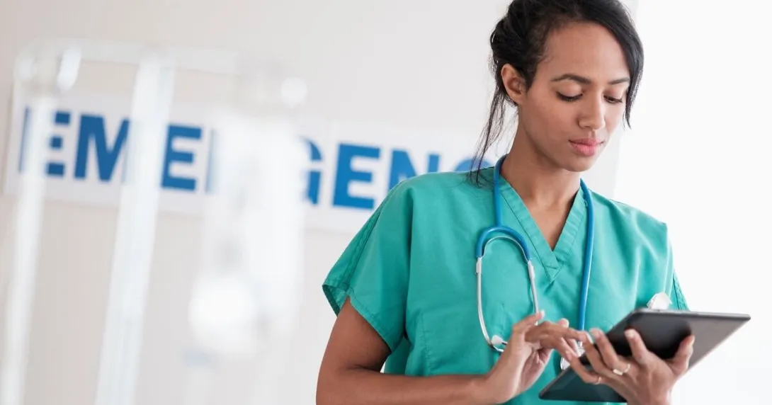 A nurse checking a patient file on a digital tablet