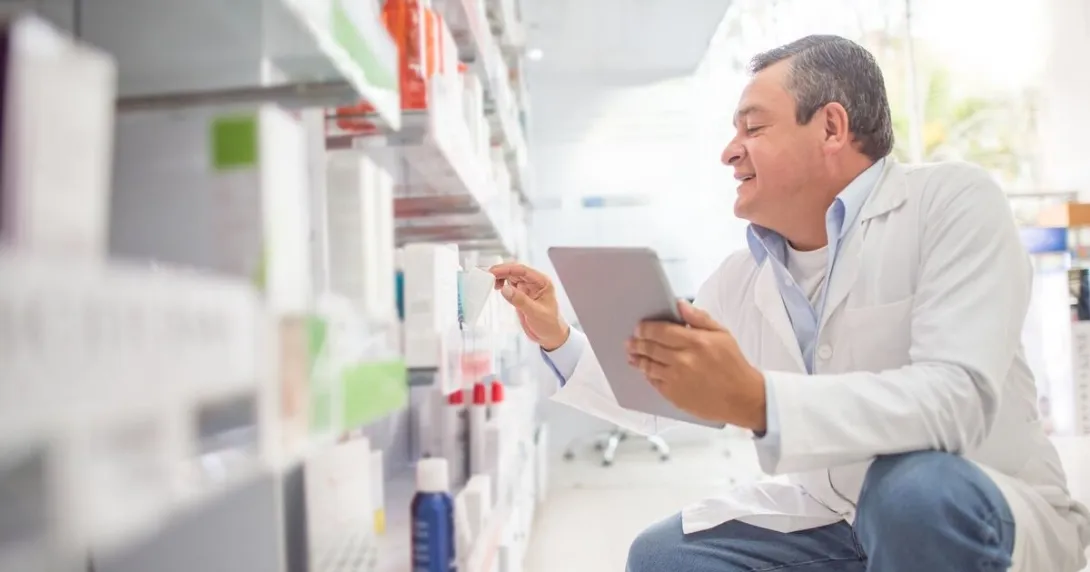 A pharmacist doing an inventory using a digital tablet