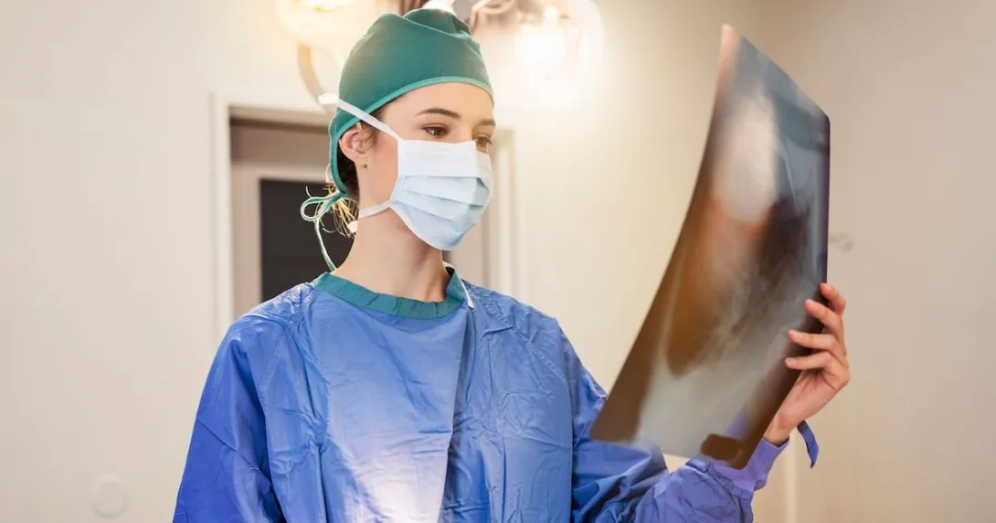 A doctor examining a patient's x-ray image
