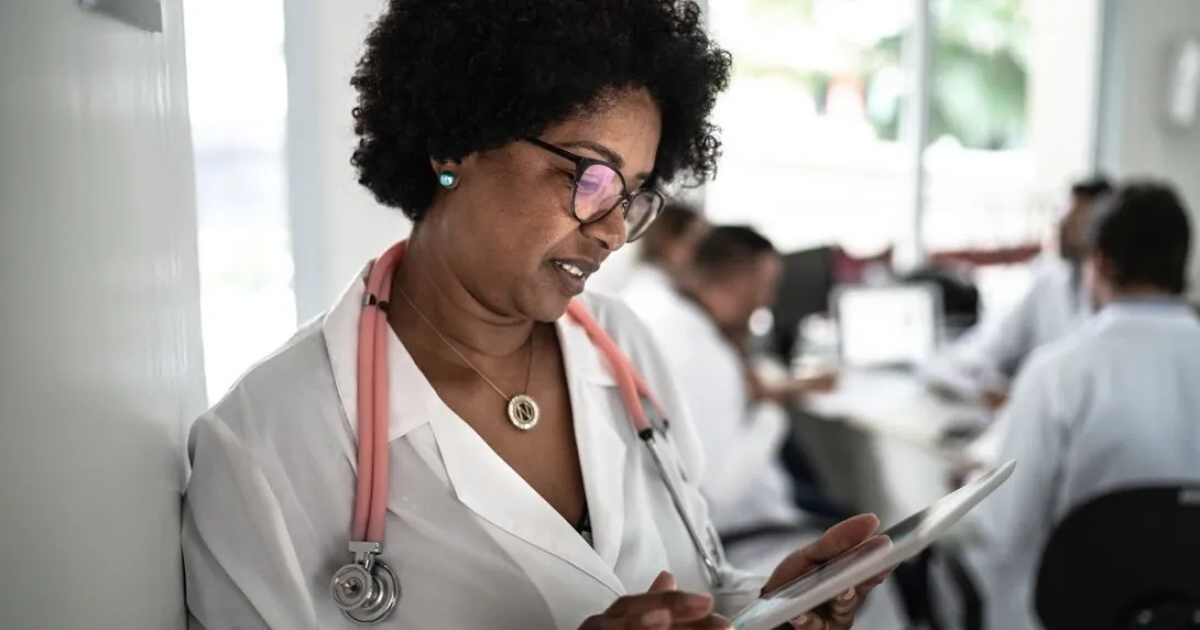 A doctor reading from a digital tablet