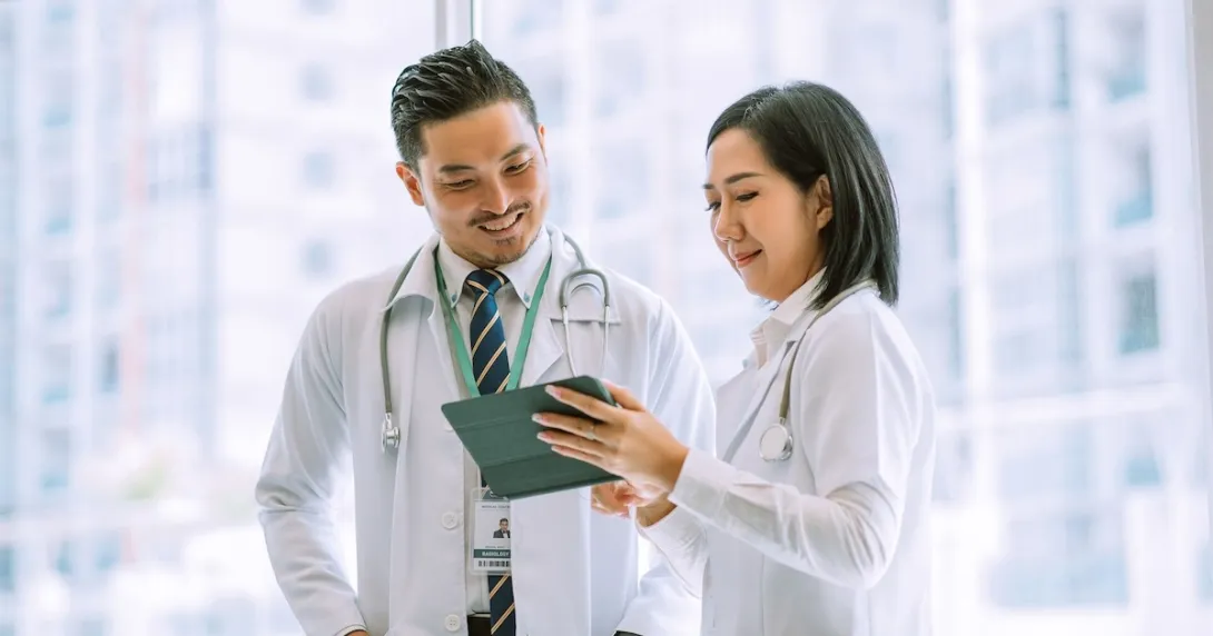 Doctors reviewing data on a digital tablet