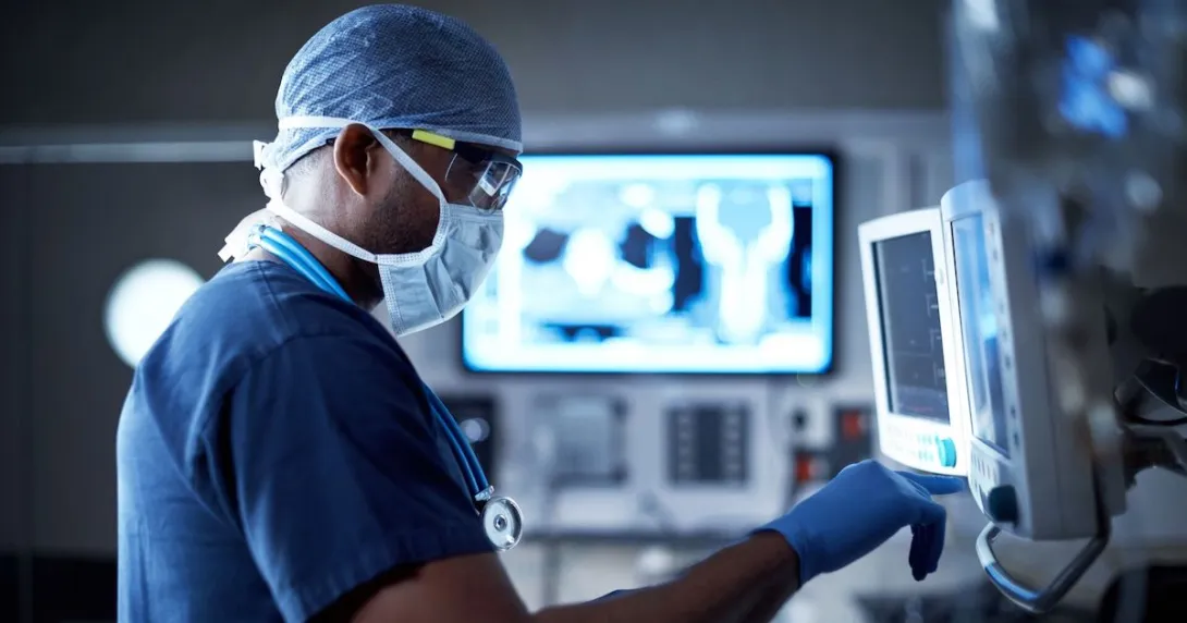 A surgeon checking a monitor in the operating room