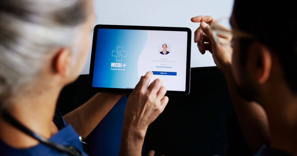 A nurse entering their portal login details on a digital tablet